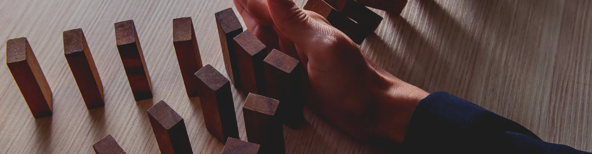 hand stopping dominos